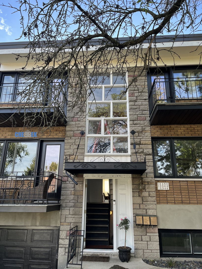 Building front with white windows before replacement