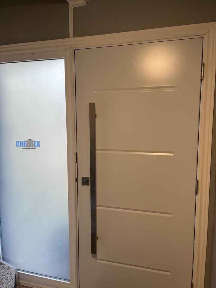 Contemporary entry door with a frosted sidelight, seen from inside