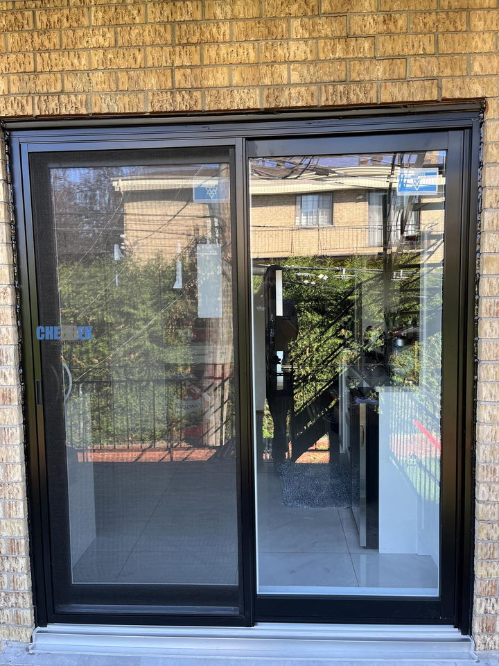 Black sliding patio door opening onto a balcony